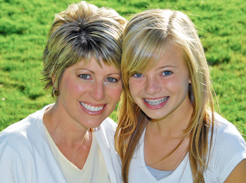 Mother and her daughter with braces.